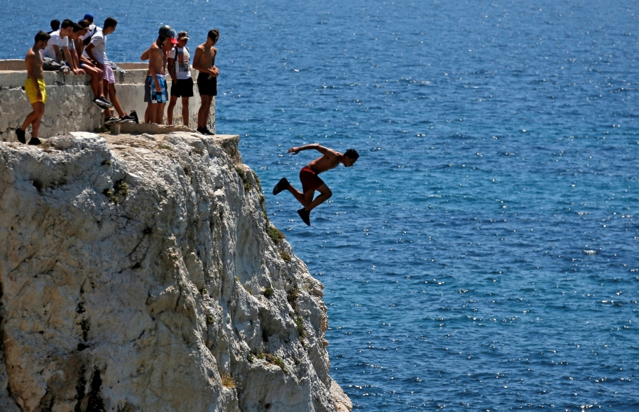 A teenager dives into the Mediterranean Sea in Marseille, France. A teenager dives into the Mediterranean Sea in Marseille, France.