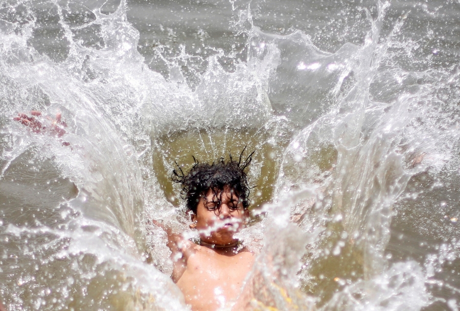 A boy jumps into the water in Cairo, Egypt. A boy jumps into the water in Cairo, Egypt.