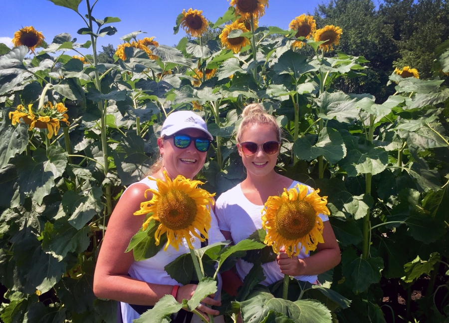 Linda St. Hilaire and her daughter Jenny in Millis, Massachusetts. Two women in a sunflower field.