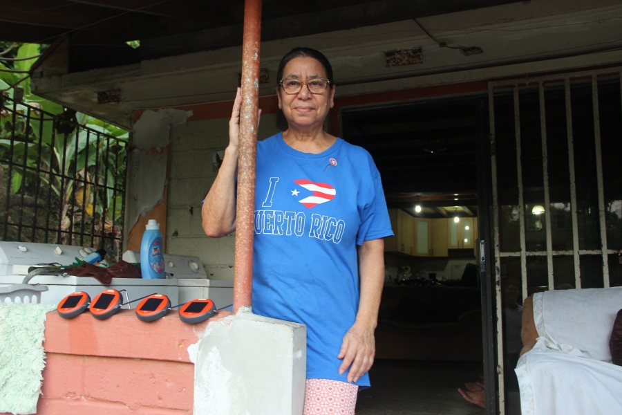 woman stands on her porch