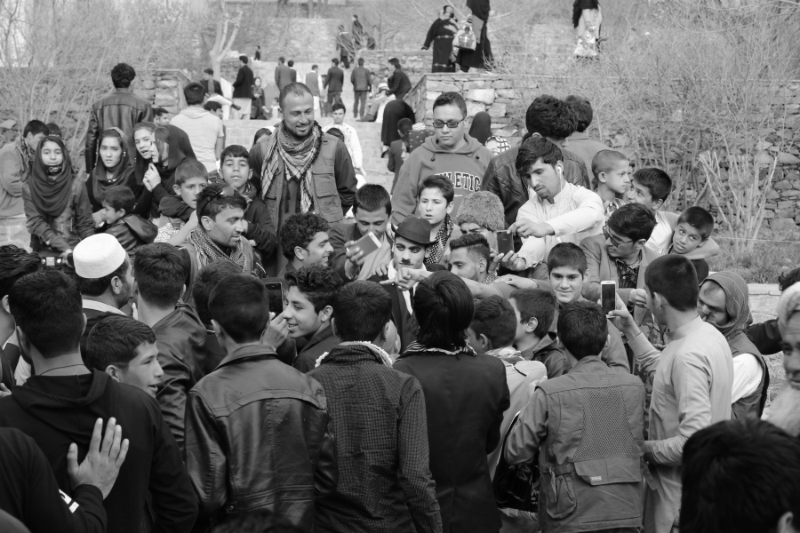 Spectators gather to take selfies with Karim Asir, also known as 'Afghani Charlie Chaplin'. Spectators gather to take selfies with Karim Asir, also known as 'Afghani Charlie Chaplin'.