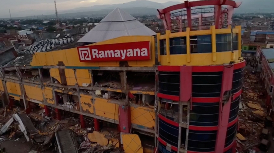 a red an yellow building collapsed