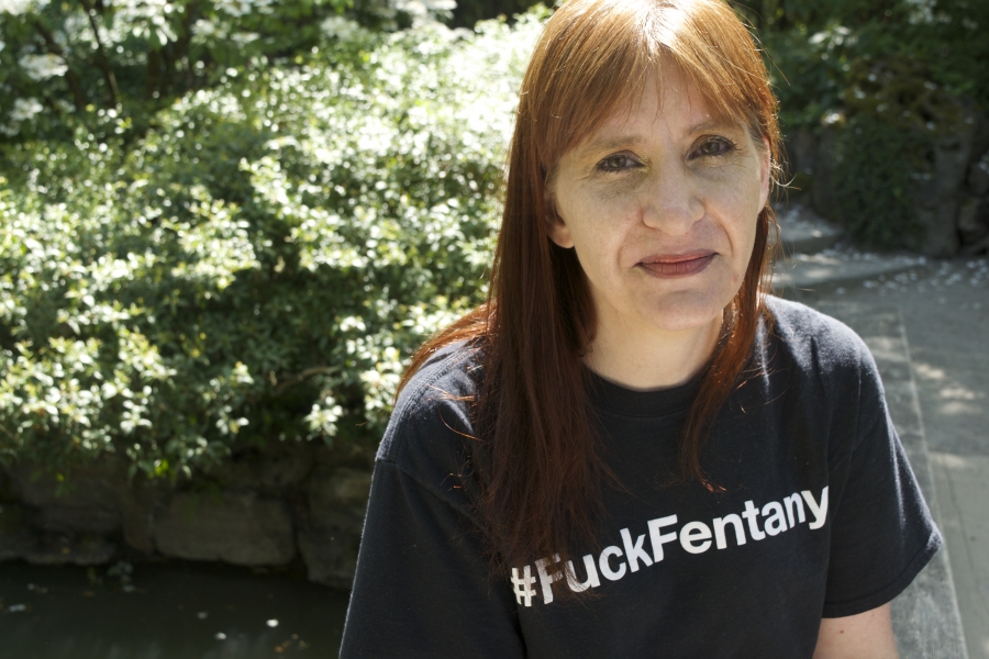 a woman with red hair wearing a black t shirt