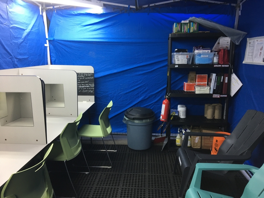 injection booths surrounded by blue tarp