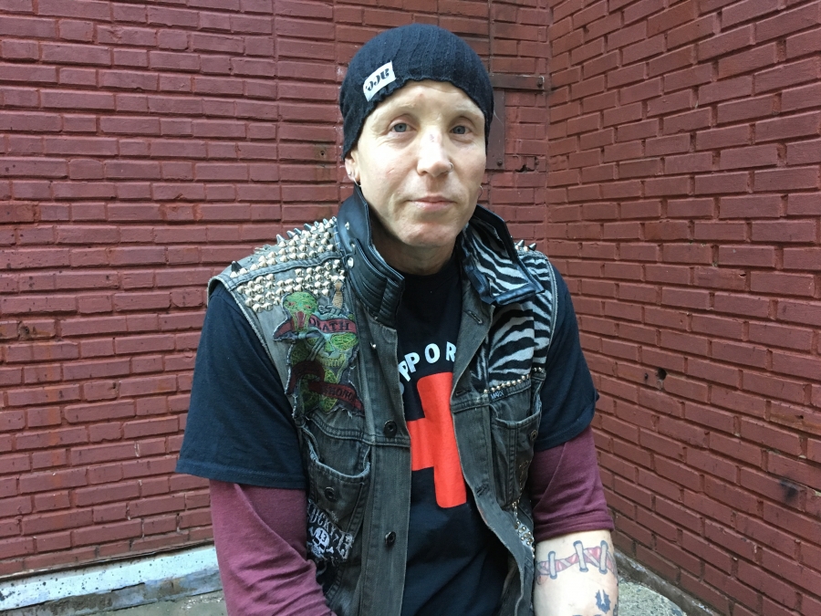a man wearing a black puffer vest and a black beanie