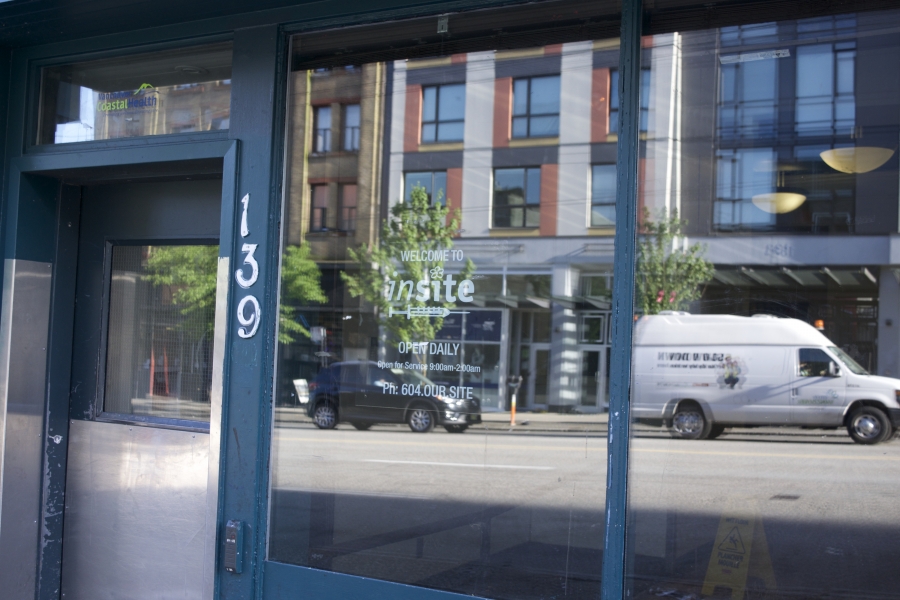 a green entrance with large windows