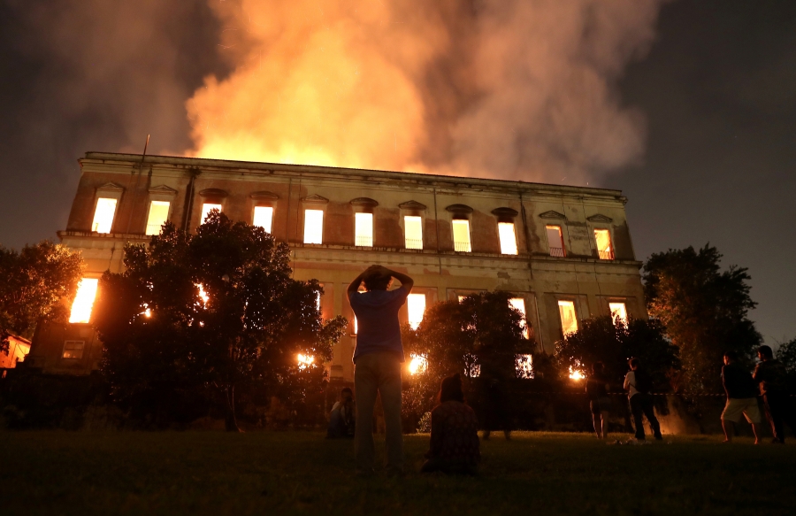 People watch as a fire burns at the National Museum of Brazil