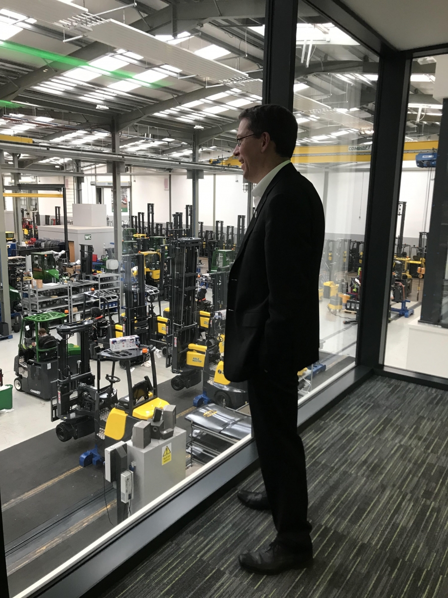 the manager of a forklift factory looks out at the plant in ireland