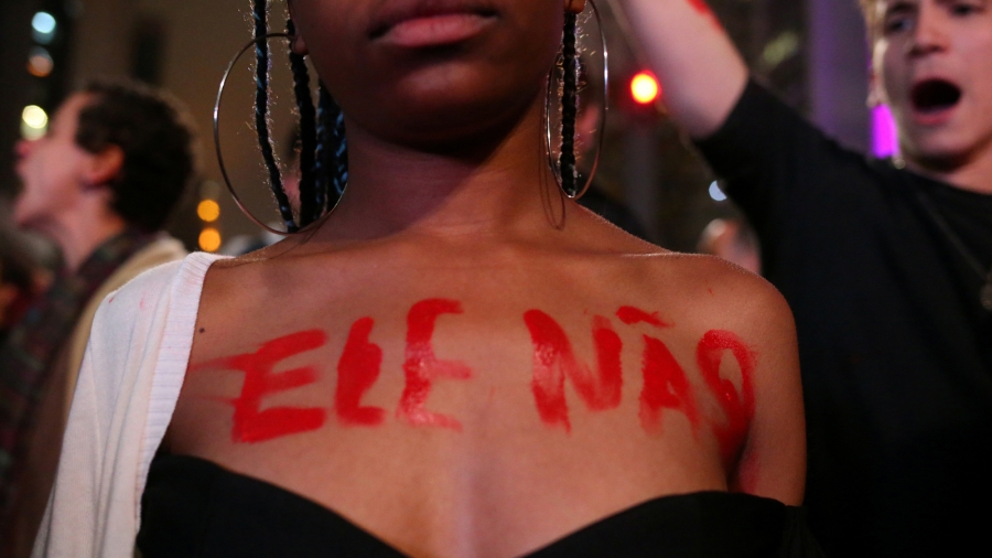 A demonstrator displays the words "Not Him" on her body in reference to Jair Bolsonaro, far-right lawmaker and presidential candidate of the Social Liberal Party (PSL), during a protest called "Against Fascism" in São Paulo, Brazil, Oct. 11, 2018. A woman writes "Not Him" in red letters on her bare chest.