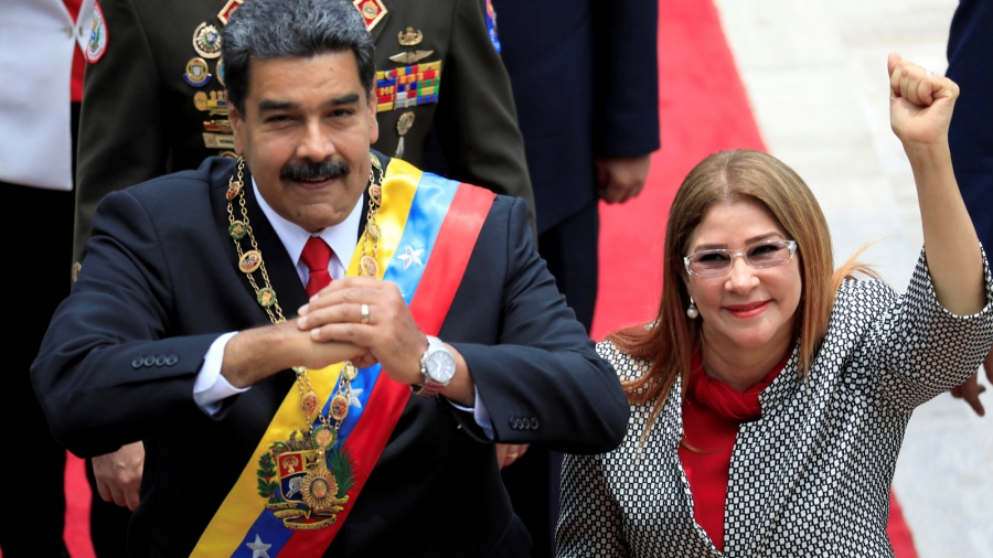 Venezuela's President Nicolás Maduro and his wife Cilia Flores gesture during arrival for a special session of the National Constituent Assembly in Caracas, Venezuela, May 24, 2018. Venezuela's President Nicolás Maduro and his wife Cilia Flores gesture during arrival for special session