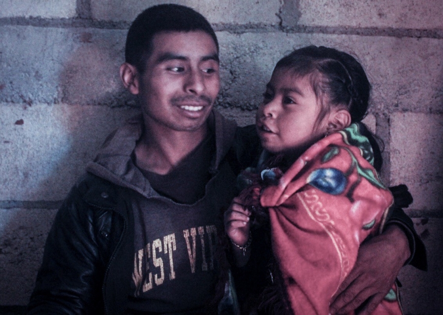 A father holds his small daughter
