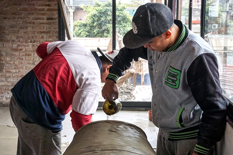 two men make a house in argentina using bricks