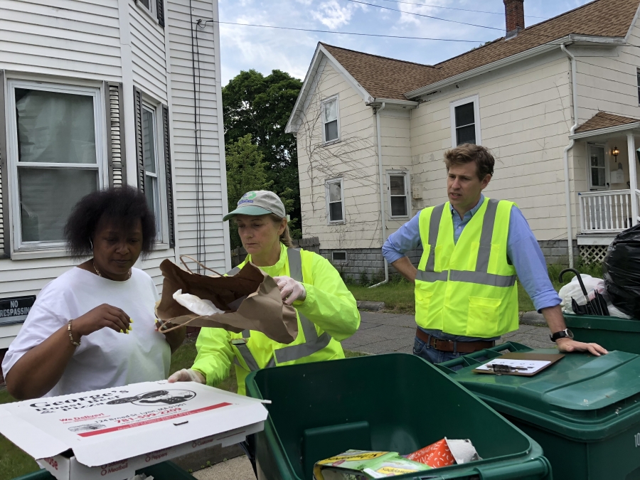 Julia Greene (center), the recycling coordinator for the city of Lynn, Mass., gives resident Diane Thomas (left) a brief tutorial on recycling. Cody Marshall, with the Recycling Partnership, looks on, offering words of encouragement. Julia Greene (center), the recycling coordinator for the city of Lynn, Mass., gives resident Diane Thomas (left) a brief tutorial on recycling. Cody Marshall, with the Recycling Partnership, looks on, offering words of encouragement.