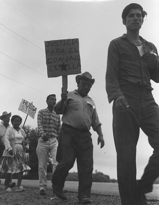 Marchers walk with signs