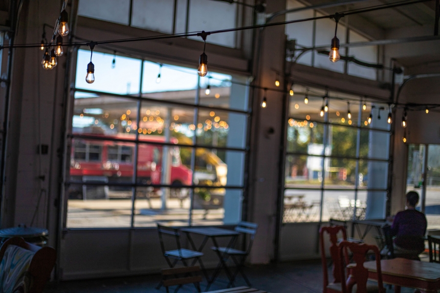 The view inside Refuge Coffee Co.’s cafe. The view inside Refuge Coffee Co.’s cafe with the cafe's string lights in focus.