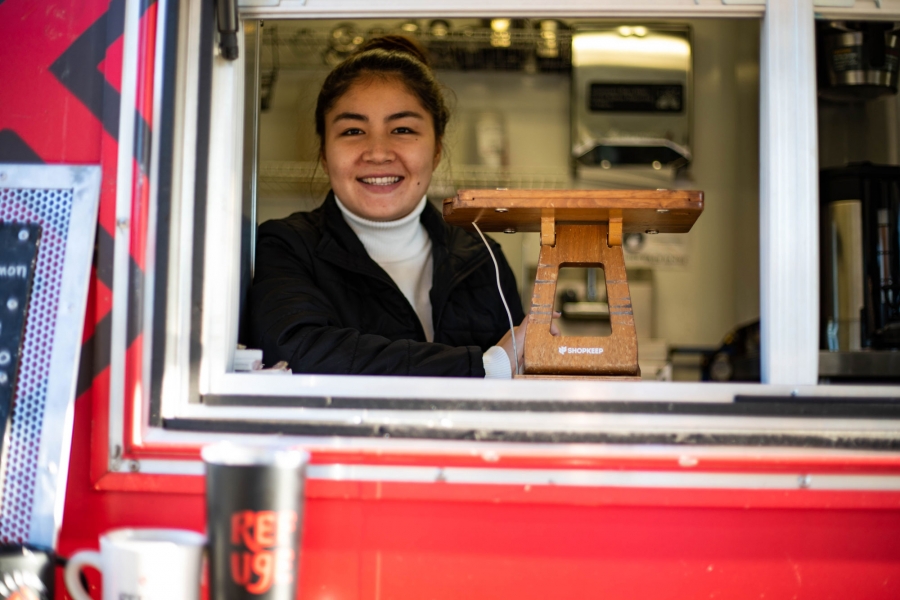 Afghan refugee and Refuge Coffee Co. employee Somayyah Maqsudi. Afghan refugee and Refuge Coffee Co. employee Somayyah Maqsudi is shown smiling in the window of the coffee truck.