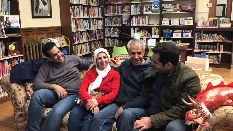 An Iranian family reunites at the Haskell Free Library and Opera House, which straddles the US-Canada border in Stanstead, Quebec and in Derby Line, Vermont, US, Nov. 3, 2018. Iranian family reunites on a couch in a library.