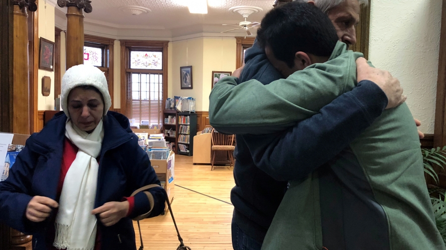 An Iranian man, a student in the United States, embraces his father as they say goodbye at the Haskell Free Library and Opera House, which straddles the US-Canada border in Stanstead, Quebec and in Derby Line, Vermont, US, Nov. 3, 2018. A man embraces his father at a library.