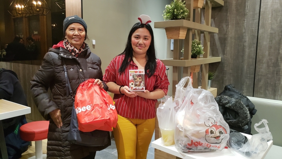 Anna Nicole Dagdagan and her aunt Rebecca Dagdagan from Staten Island attend the Jollibee grand opening in NYC. A young woman poses with her aunt at Jollibee in NYC