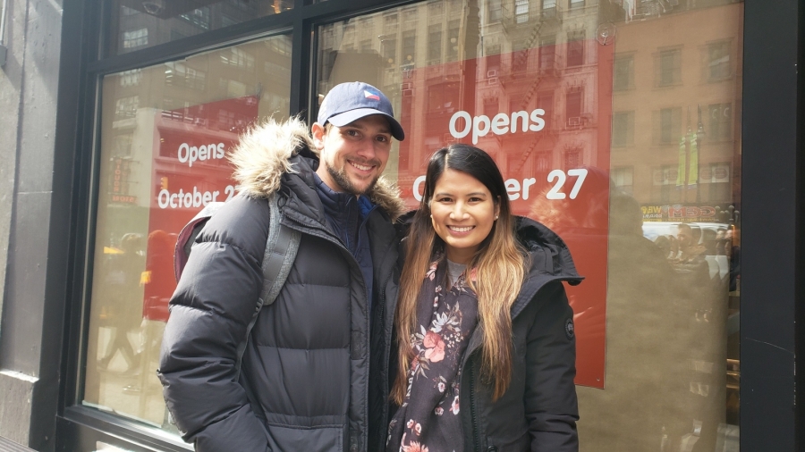Justin Callan and Faye Javier were first in line and fully equipped to spend 20 hours on the sidewalk in the rain for a taste of Jollibee. A man and woman wear winter gear while waiting in line at Jollibee.