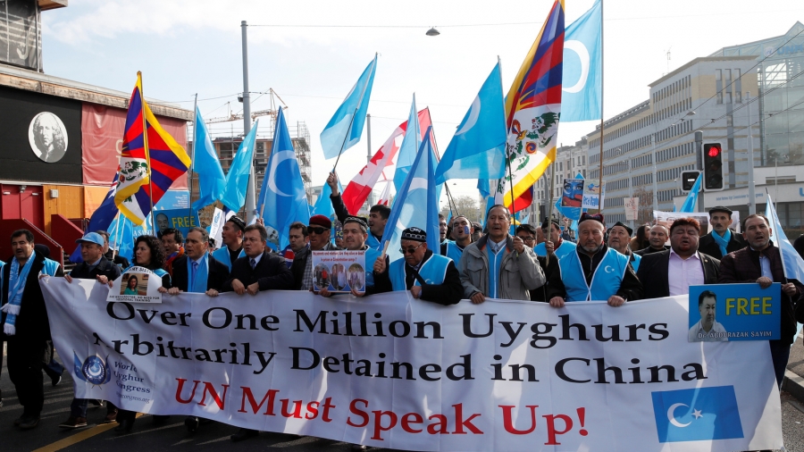 People demonstrate against China during its Universal Periodic Review by the Human Rights Council in front of the United Nations Office in Geneva, Switzerland, Nov. 6, 2018. A group of protestors demonstrate with signs.
