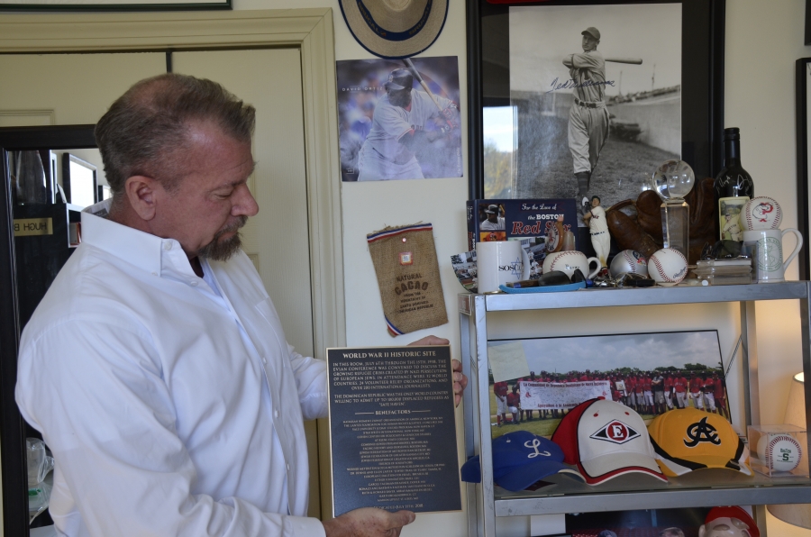 Hugh Baver, in his office in Dover, NH, holds the plaque that will hang at the Hotel Royal in France where the Evian Conference took place in 1938. Hugh Baver, in his office in Dover, NH, holds the plaque that will hang at the Hotel Royal in France where the Evian Conference took place in 1938.