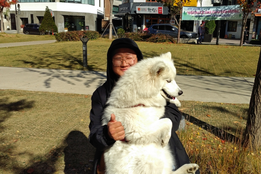 Kim Jong-yoon, 31, from Yongin, South Korea. Kim Jong-yoon hugs a white dog.