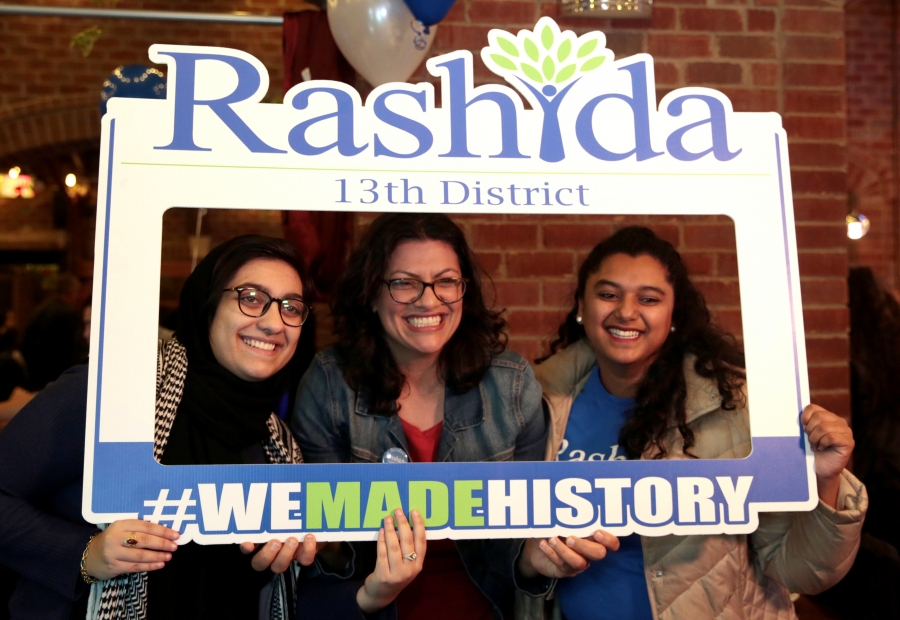 Three woman stand in Instagram-style frame that reads: "Rashida 13th District #wemadehistory"