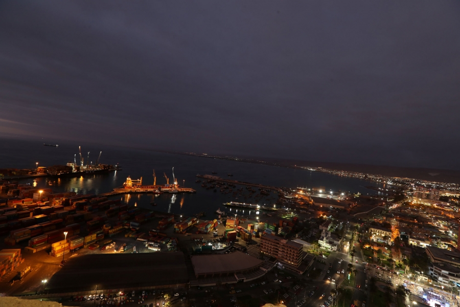 Arica city near the Chilean and Peruvian border. In this wide angle photo taken at dusk, Arica city is shown with shipping facilities on the water.