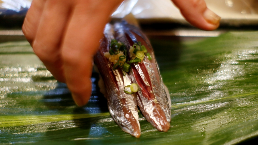 Masatoshi Fukutsuna, chef and owner of sushi restaurant Eiraku, serves sushi to a customer at his restaurant in Tokyo, Japan, Dec. 7, 2018. Sushi close up shot.