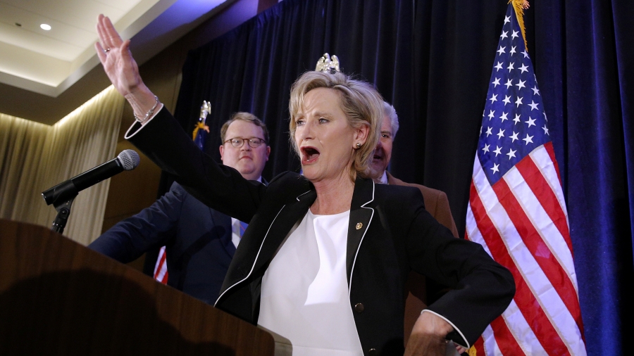Republican US Senator Cindy Hyde-Smith speaks during an election night party in Jackson, Mississippi, Nov. 27, 2018. Republican US Senator Cindy Hyde-Smith raise her arm up at the podium on election night.
