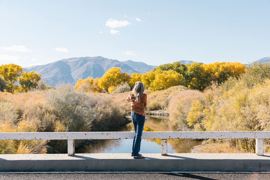 Stephanie Doane came to Smith Valley to enjoy the natural world. A woman stands with her back turned against a mountain landscape.