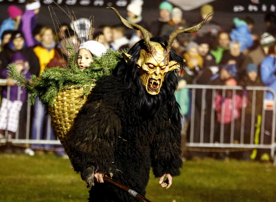 Krampus carrying a bad child away in a basket