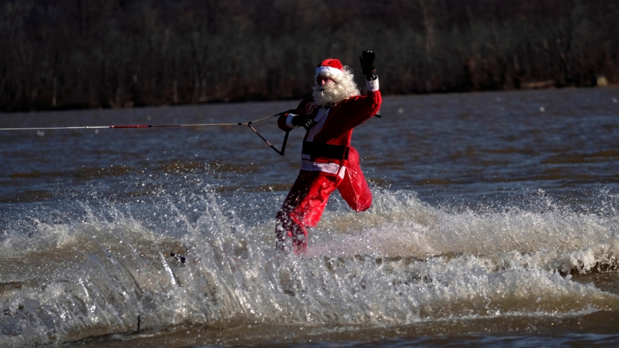 Waterskiing Santa in Alexandria, Virginia. A man dressed up as Santa Claus waterskis on a river.