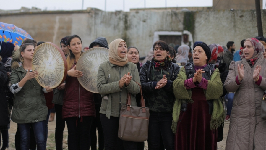 Women in a cluster chant slogans.