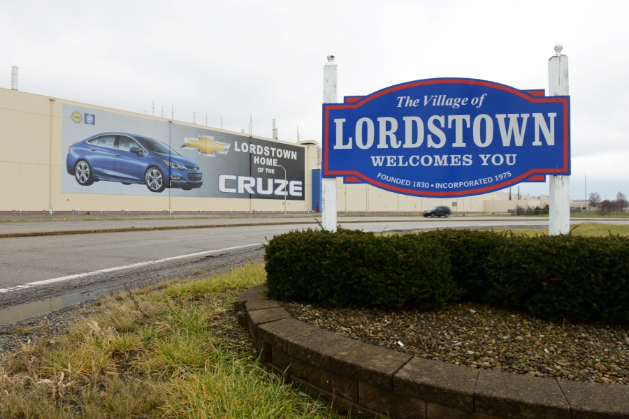 The General Motors Lordstown, Ohio, complex opened in 1966. The plant pays nearly $400 million to workers there, generating close to $80 million in payroll taxes. It’s scheduled to shut down in March. A blue and white Lordstown, Ohio, welcome sign along a bend in the road.
