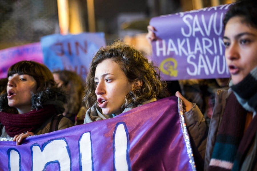 Women hold protest signs in a march