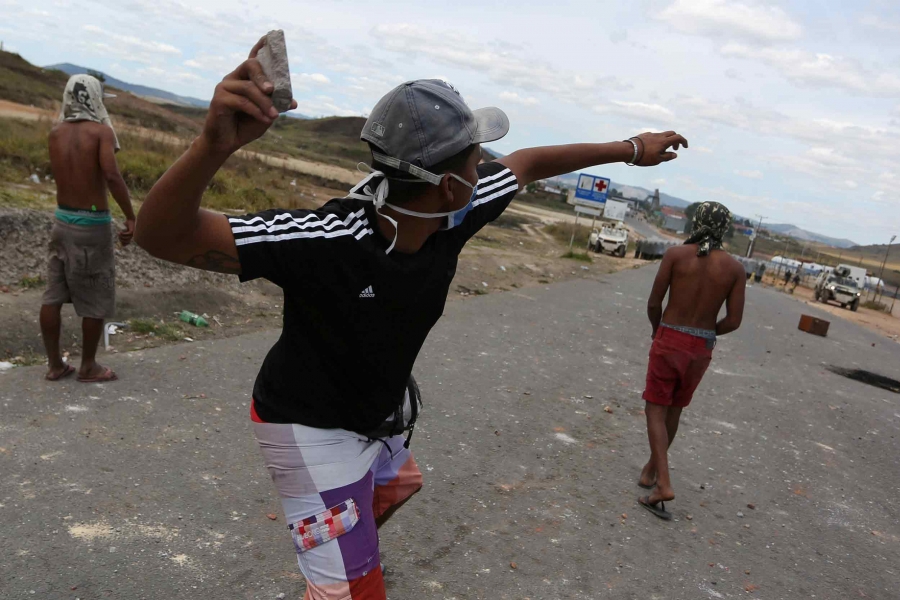 Man throws rock.