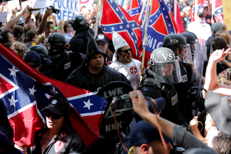 Men in Klan hoods, black hoods and police in riot gear