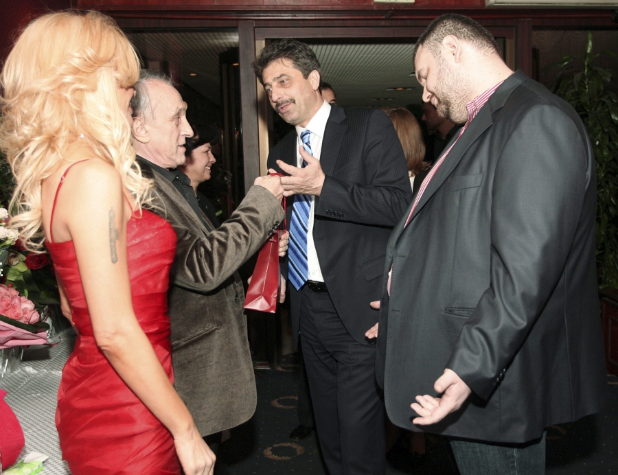 two men in suits greet each other