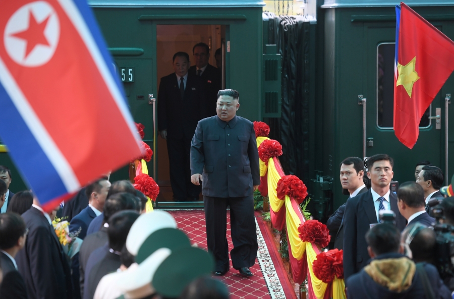 Kim exits forest-green colored train car.