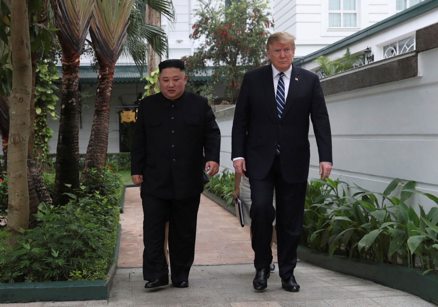 US President Donald Trump and North Korea's leader Kim Jong-un walk in the garden at the Metropole hotel in Hanoi, Vietnam. US President Donald Trump and North Korea's leader Kim Jong-un are shown walking side-by-side in a white-walled garden.