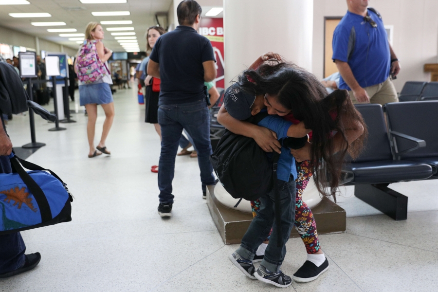A mother hugs her son in the airport A mother hugs her son in the airport