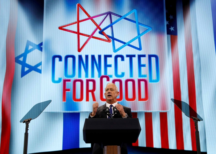 Israel's Blue and White party leader Benny Gantz speaks at AIPAC in Washington, DC, on March 25, 2019. The screen behind him says "connected for good."