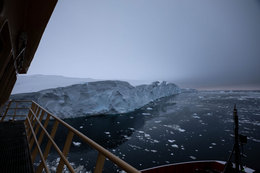 On the first day at Thwaites Glacier, the Nathaniel B. Palmer traced a roughly 100-mile path around the edge. The railing of the Nathaniel B. Palmer is shown with Thwaites Glacier in the distance.