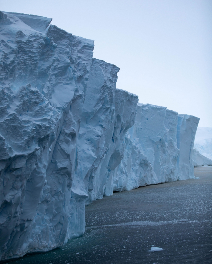 The front face of Thwaites glacier rises an estimated 60 to 75 feet above water in the areas where it is most intact. The front face of Thwaites glacier is shown rising an estimated 60 to 75 feet above the dark blue ocean waters.