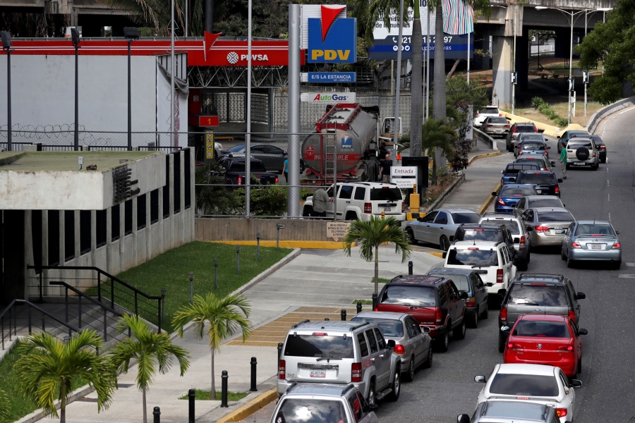 Cars line up for fuel at a gas station a blackout in Caracas, Venezuela. A long line of cars are shown down the street of a gas station in Caracas.