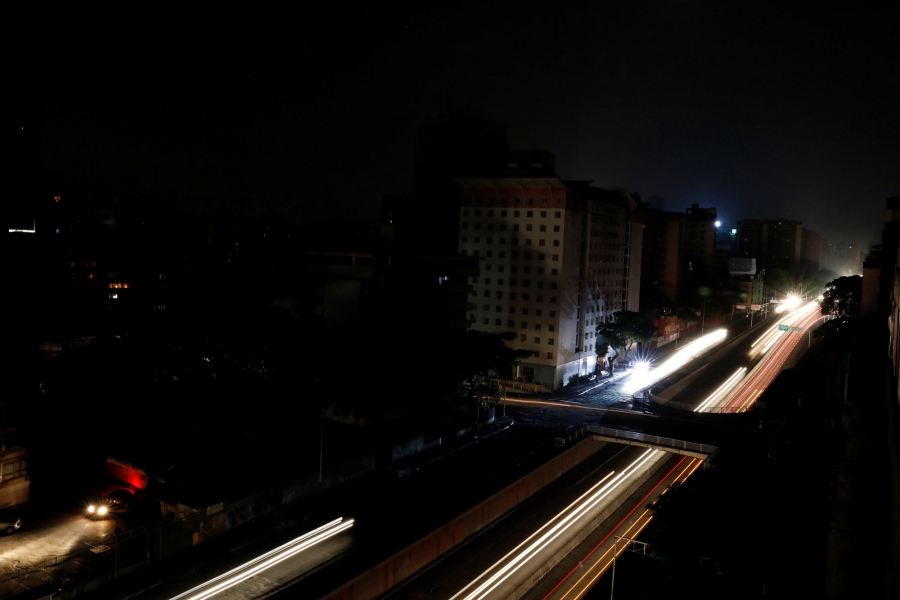 Cars drive down one of the main roads of Caracas during the blackout. The lights from cars blur into long yellow and red lines down one of the main roads of Caracas during the blackout.