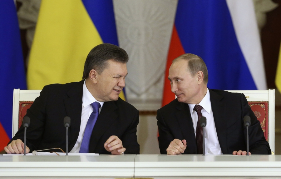 Former Ukrainian President Viktor Yanukovich, left, gives a wink to his Russian counterpart Vladimir Putin