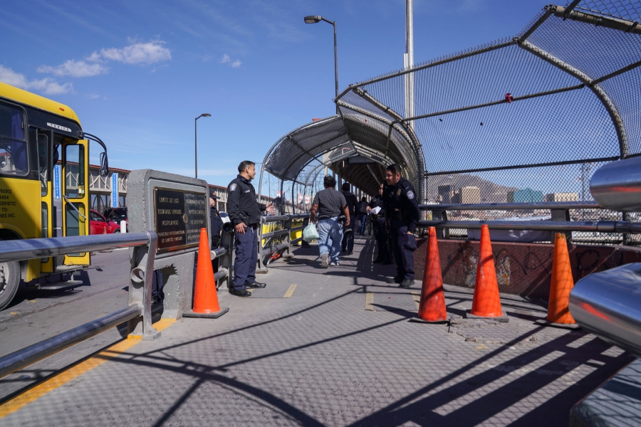 Customs and Border Protection agents check the legal documents of people crossing from Ciudad Juárez to El Paso on the bridge that divides the two cities. Two Mexican border security officers are show at the entryway to the Mexico-US bordercrossing